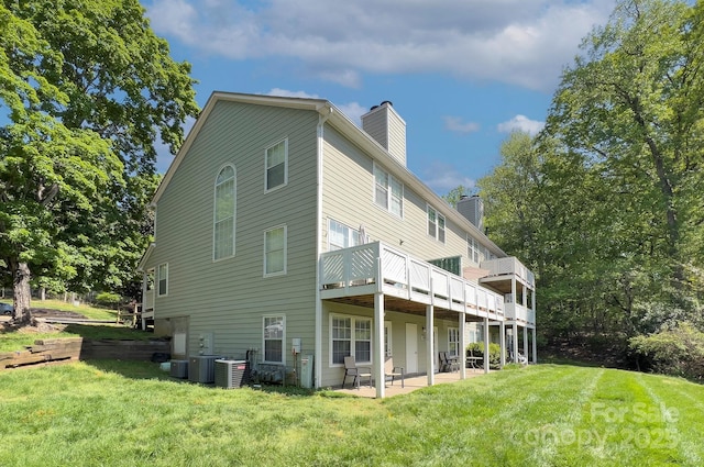 6510 Clavell Ln Unit B, Charlotte, NC 28210 - back of property featuring a chimney, a patio, central AC unit, and a lawn