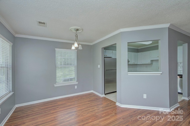 6510 Clavell Ln Unit B, Charlotte, NC 28210 - unfurnished room with baseboards, visible vents, wood finished floors, and a textured ceiling