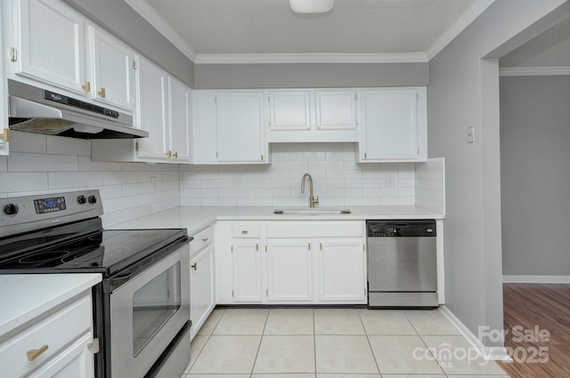 6510 Clavell Ln Unit B, Charlotte, NC 28210 - kitchen featuring stainless steel appliances, under cabinet range hood, light countertops, ornamental molding, and a sink