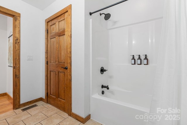 bathroom with tile patterned flooring, shower / bathtub combination with curtain, visible vents, and baseboards