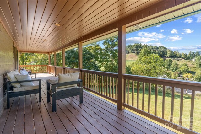 deck with a yard and an outdoor hangout area
