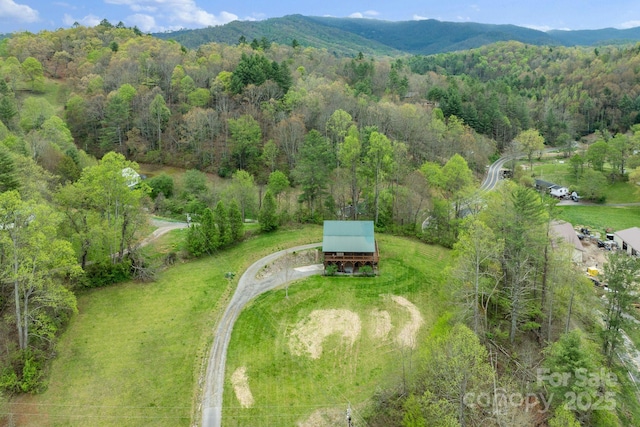drone / aerial view with a mountain view and a forest view