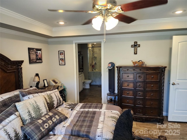 bedroom featuring ornamental molding, a ceiling fan, ensuite bath, and wood finished floors