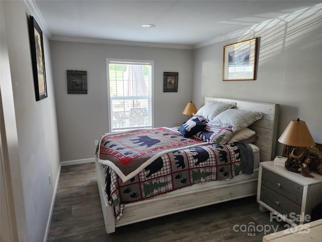 bedroom featuring baseboards, ornamental molding, and wood finished floors