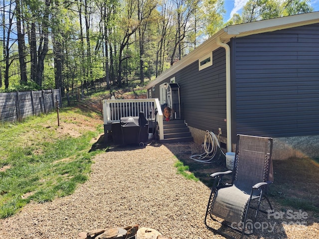 view of yard with a deck and fence