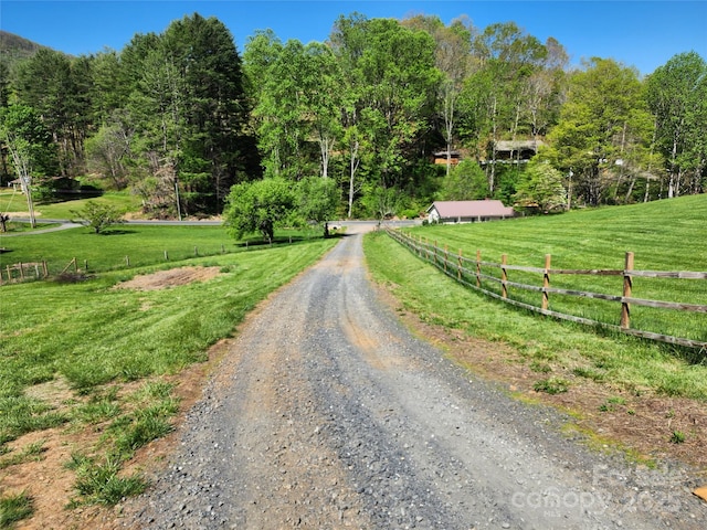 view of road with driveway and a rural view