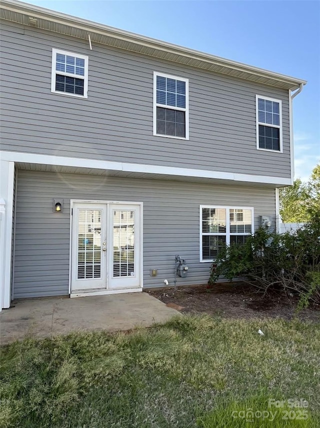 back of property featuring a lawn and a patio area