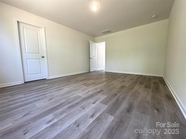 213 Salem Springs Ln, Statesville, NC 28625 - unfurnished room featuring visible vents, baseboards, and dark wood-style flooring