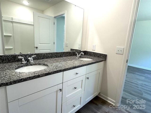 213 Salem Springs Ln, Statesville, NC 28625 - full bath featuring double vanity, wood finished floors, baseboards, and a sink