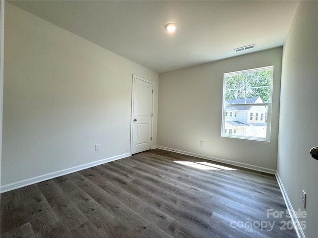 213 Salem Springs Ln, Statesville, NC 28625 - spare room with visible vents, baseboards, and dark wood-style floors