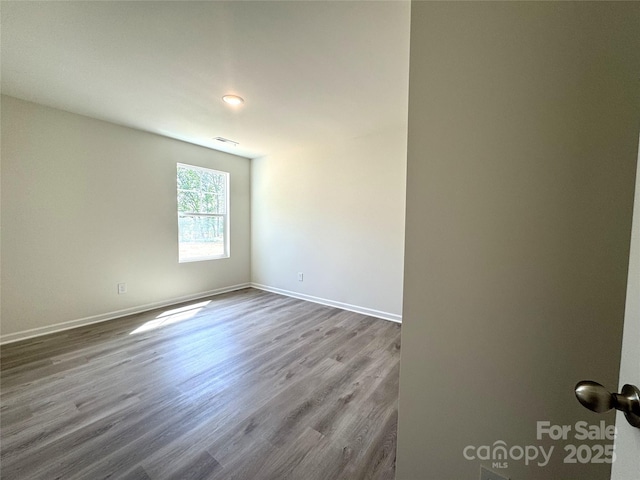 213 Salem Springs Ln, Statesville, NC 28625 - unfurnished room with wood finished floors, visible vents, and baseboards