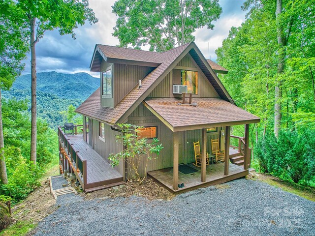 171 Jade Dr, Clyde, NC 28721 - view of front of home with roof with shingles, a wooden deck, and cooling unit