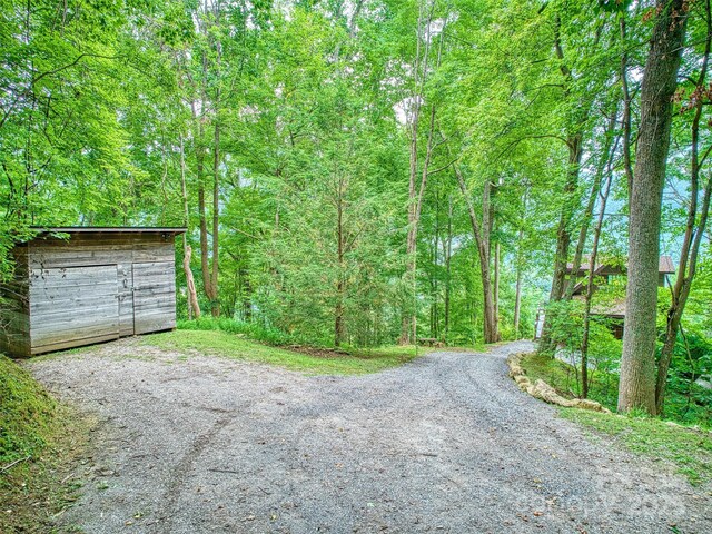 171 Jade Dr, Clyde, NC 28721 - view of dirt / gravel road with a forest view
