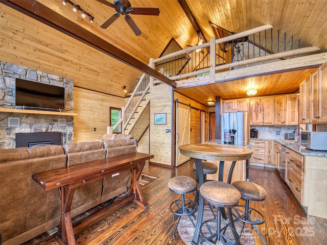 171 Jade Dr, Clyde, NC 28721 - living area with high vaulted ceiling, dark wood-style flooring, ceiling fan, stairway, and wood ceiling with exposed beams