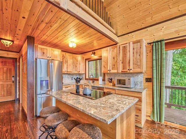 171 Jade Dr, Clyde, NC 28721 - kitchen featuring stainless steel refrigerator with ice dispenser, white microwave, decorative backsplash, dark wood-style flooring, and a sink