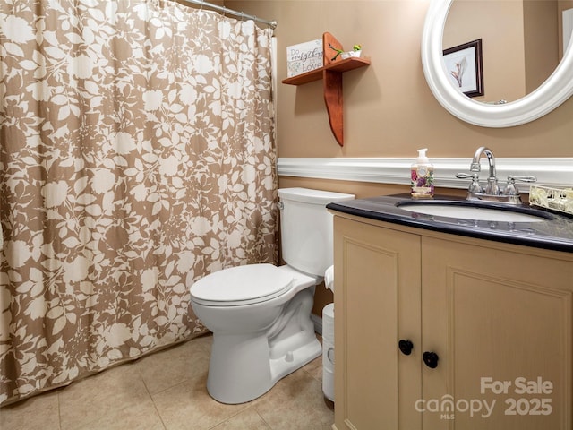 bathroom with vanity, toilet, a shower with curtain, and tile patterned flooring