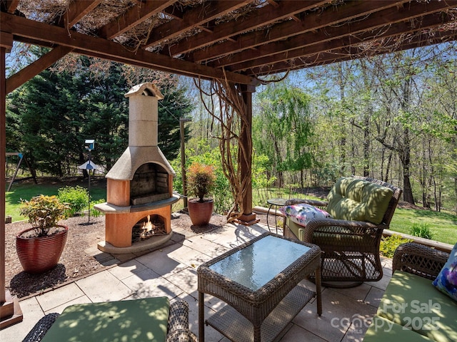 view of patio / terrace featuring an outdoor fireplace