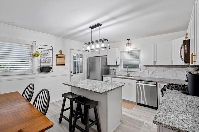 4314 Oak Forest Dr, Charlotte, NC 28215 - kitchen with a sink, a kitchen island, appliances with stainless steel finishes, and tasteful backsplash