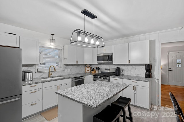 4314 Oak Forest Dr, Charlotte, NC 28215 - kitchen with white cabinets, stainless steel appliances, decorative backsplash, and a sink