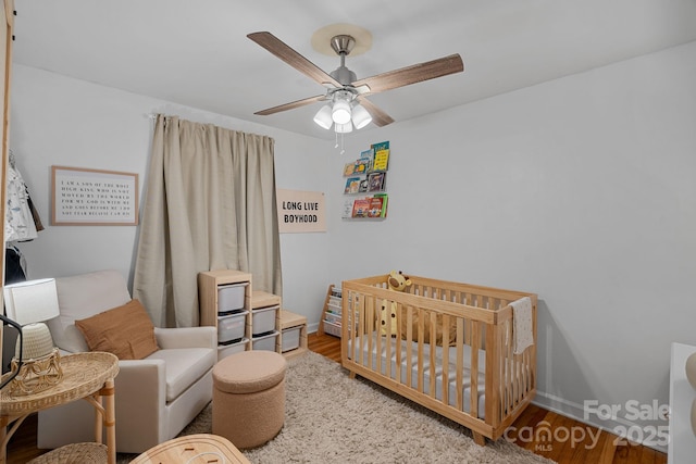 4314 Oak Forest Dr, Charlotte, NC 28215 - bedroom featuring ceiling fan, wood finished floors, and a crib