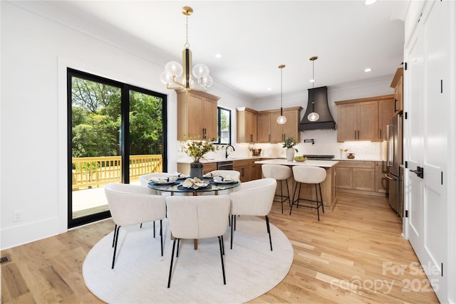 816 Tennyson Dr, Charlotte, NC 28208 - dining area featuring a notable chandelier, ornamental molding, and light wood finished floors