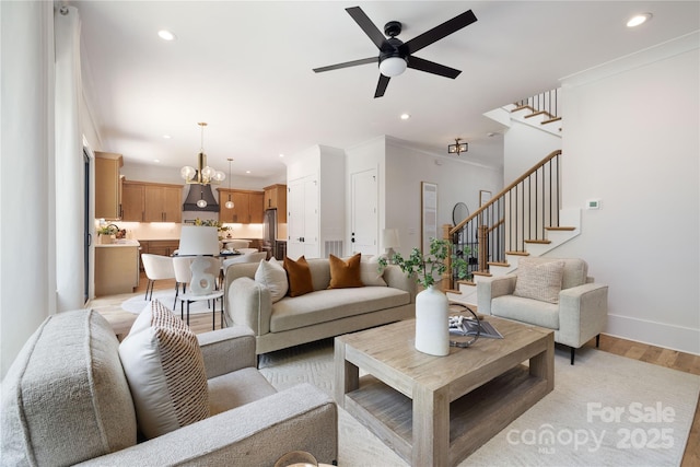 816 Tennyson Dr, Charlotte, NC 28208 - living room with a ceiling fan, stairs, ornamental molding, recessed lighting, and light wood-style flooring