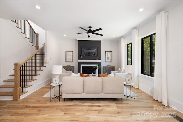 816 Tennyson Dr, Charlotte, NC 28208 - living area featuring light wood-type flooring, recessed lighting, ceiling fan, and stairway