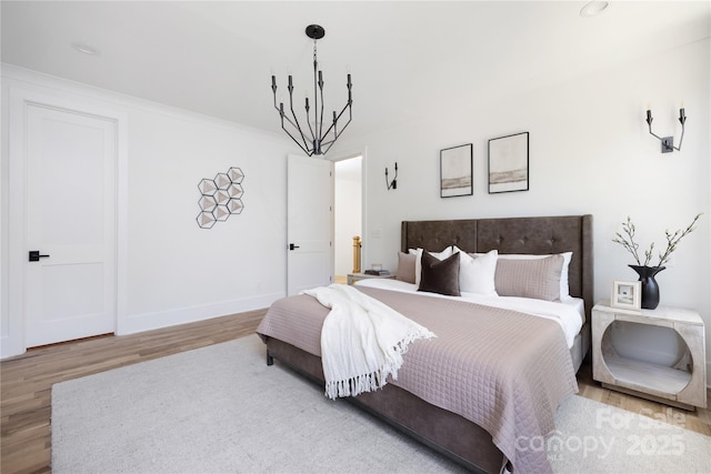 816 Tennyson Dr, Charlotte, NC 28208 - bedroom with baseboards, ornamental molding, wood finished floors, and a notable chandelier