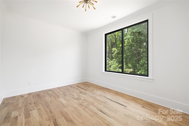 816 Tennyson Dr, Charlotte, NC 28208 - spare room with baseboards, visible vents, ornamental molding, and wood finished floors