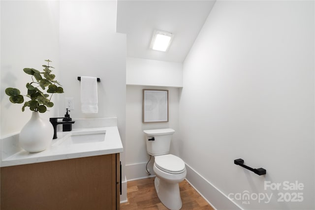 816 Tennyson Dr, Charlotte, NC 28208 - bathroom with toilet, baseboards, wood finished floors, and vanity