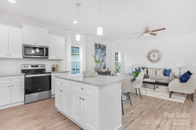 1619 Martin Ave, Gastonia, NC 28052 - kitchen with stainless steel appliances, light wood finished floors, open floor plan, ceiling fan, and a kitchen island