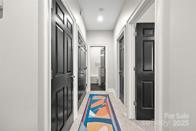 corridor featuring baseboards