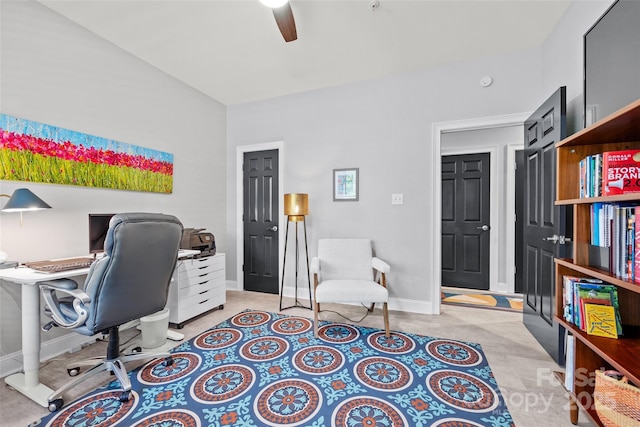 office area with a ceiling fan and baseboards