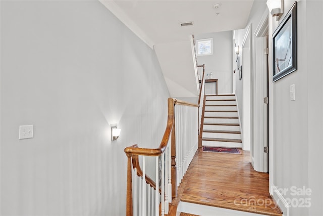 stairs featuring visible vents and wood finished floors