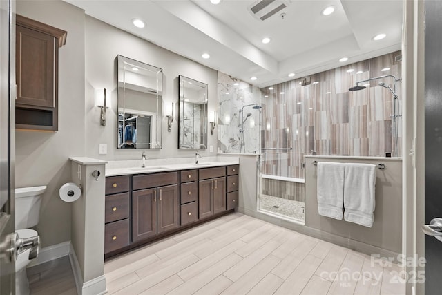 full bathroom featuring toilet, recessed lighting, and a sink