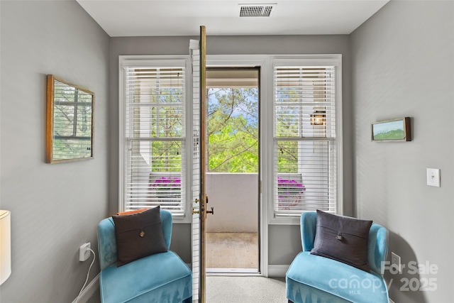 sitting room featuring baseboards, visible vents, and carpet floors