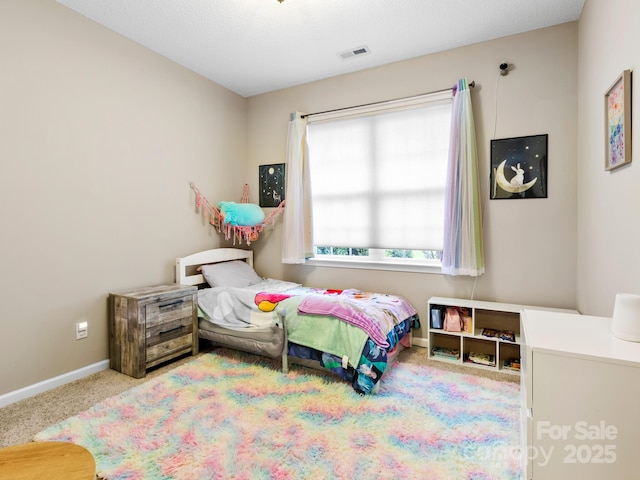 carpeted bedroom with baseboards and visible vents