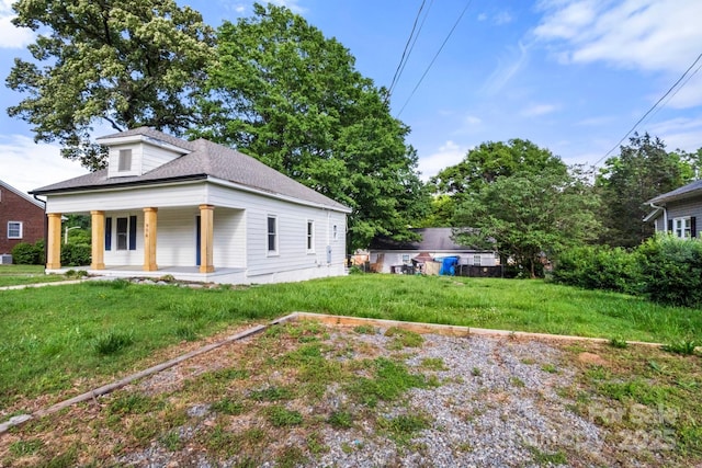view of front of property with covered porch and a front lawn