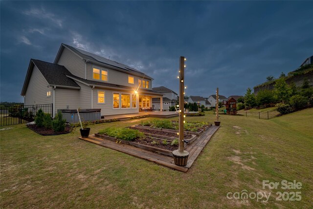 528 Rock Skip Way, Fort Mill, SC 29708 - back of house with a garden, solar panels, a hot tub, and a patio area