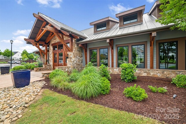 528 Rock Skip Way, Fort Mill, SC 29708 - view of front of home with stone siding, a standing seam roof, and a metal roof
