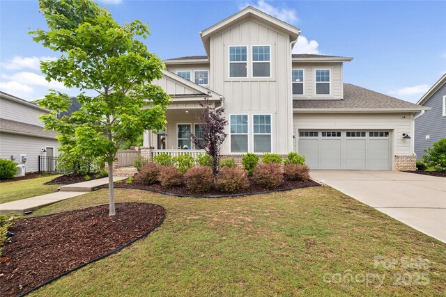 528 Rock Skip Way, Fort Mill, SC 29708 - craftsman-style house with board and batten siding, concrete driveway, a front lawn, covered porch, and brick siding