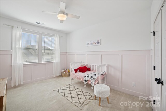 528 Rock Skip Way, Fort Mill, SC 29708 - carpeted bedroom with a decorative wall, wainscoting, and ceiling fan