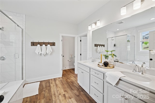528 Rock Skip Way, Fort Mill, SC 29708 - bathroom featuring a stall shower, double vanity, wood finished floors, and a tub
