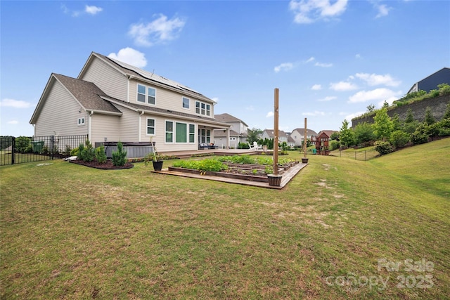 528 Rock Skip Way, Fort Mill, SC 29708 - rear view of house with a garden, roof mounted solar panels, and a fenced backyard