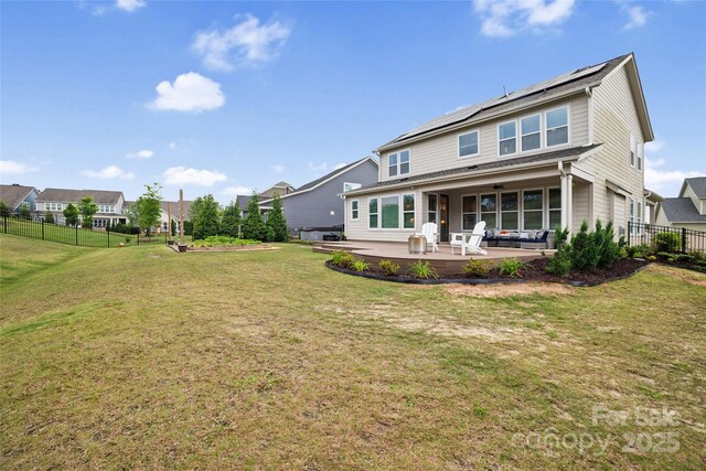 528 Rock Skip Way, Fort Mill, SC 29708 - rear view of house featuring roof mounted solar panels, a patio, ceiling fan, and a fenced backyard