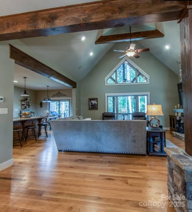 living area with ceiling fan, beam ceiling, light wood finished floors, high vaulted ceiling, and recessed lighting
