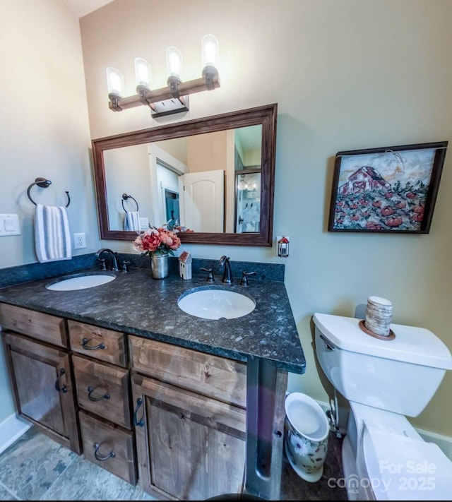 full bathroom with toilet and double vanity
