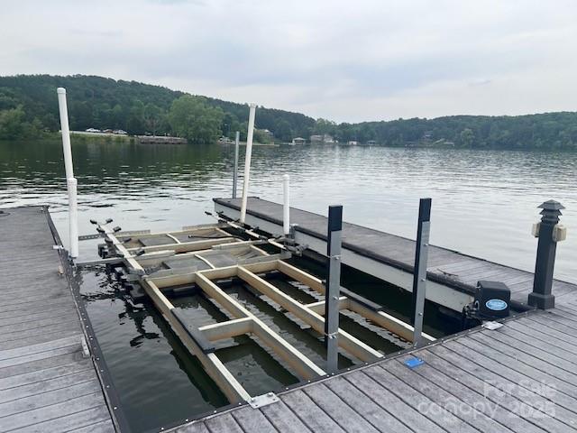 dock with a water view and a forest view