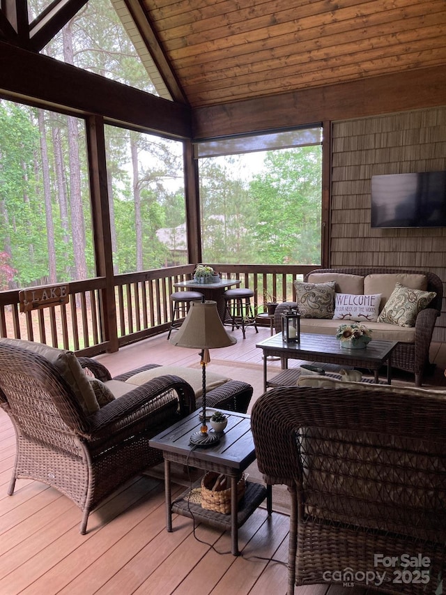 sunroom featuring an outdoor living space and vaulted ceiling