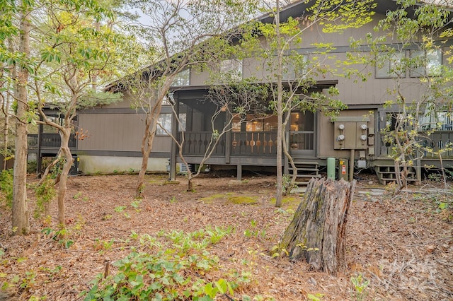 back of house featuring a sunroom